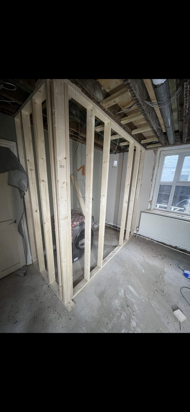 A finished media wall built and plastered by GRF Construction